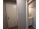 This home features a bathroom near the hall with a vanity and white door at 5024 Se 109Th St, Belleview, FL 34420