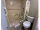 Bathroom with shower, toilet and accessibility grab bar for safety and convenience at 5024 Se 109Th St, Belleview, FL 34420