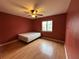 Cozy bedroom features laminate floors, a window, and a ceiling fan at 5024 Se 109Th St, Belleview, FL 34420