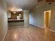 Open-concept living room with warm flooring and seamless flow into the kitchen area at 5024 Se 109Th St, Belleview, FL 34420