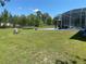 Large backyard with grass, a swimming pool, and a screened-in lanai at 5323 Sw 111Th Lane Rd, Ocala, FL 34476