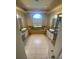 Bright bathroom with a large tub, dual sinks, granite counters, and a decorative arched window at 5323 Sw 111Th Lane Rd, Ocala, FL 34476