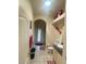 Charming bathroom featuring a toilet, vanity, decorative shelves, and a glass door shower at 5323 Sw 111Th Lane Rd, Ocala, FL 34476