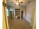 Bedroom featuring a ceiling fan, built-in desk with shelving and two mirrored door closets at 5323 Sw 111Th Lane Rd, Ocala, FL 34476