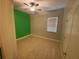 Bedroom with tile floors, a ceiling fan, and a bright green accent wall at 5323 Sw 111Th Lane Rd, Ocala, FL 34476