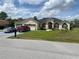Charming single-story home featuring a manicured front yard, and a circular driveway at 5323 Sw 111Th Lane Rd, Ocala, FL 34476