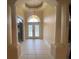 Elegant foyer with tile flooring, arched doorway, decorative glass door and columned entry at 5323 Sw 111Th Lane Rd, Ocala, FL 34476