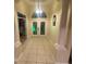 Inviting foyer featuring a double-door entry with decorative glass and tiled flooring at 5323 Sw 111Th Lane Rd, Ocala, FL 34476