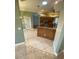 Bright kitchen featuring a breakfast bar, wood cabinets and a view into the entry of the home at 5323 Sw 111Th Lane Rd, Ocala, FL 34476