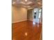 Open-concept living room boasts hardwood floors, coffered ceilings, and natural light at 5323 Sw 111Th Lane Rd, Ocala, FL 34476