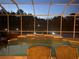 Enclosed pool with a raised tile-faced spa and chairs under a screened enclosure at 5323 Sw 111Th Lane Rd, Ocala, FL 34476