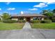 Charming single-story home featuring mature landscaping, a well-manicured lawn, and a welcoming front entrance at 5950 Sw 21St Avenue Rd, Ocala, FL 34471