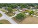 Single-story home with a large, fenced-in yard and two storage sheds, set amongst mature trees at 6701 Nw 6Th Ave, Ocala, FL 34475