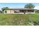 Backyard view highlighting the home's screened porch and spacious yard at 6701 Nw 6Th Ave, Ocala, FL 34475