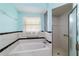 Bright bathroom featuring a shower stall and separate tub with tile surround at 6701 Nw 6Th Ave, Ocala, FL 34475