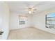 Bright, carpeted bedroom with a ceiling fan and natural light at 6701 Nw 6Th Ave, Ocala, FL 34475