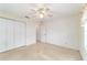 Bright bedroom featuring a ceiling fan and closet at 6701 Nw 6Th Ave, Ocala, FL 34475