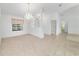 Light-filled dining area with tile flooring, a chandelier, and views into the living spaces at 6701 Nw 6Th Ave, Ocala, FL 34475