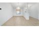 Bright dining area with tiled floors, large window, chandelier, and easy access to the foyer at 6701 Nw 6Th Ave, Ocala, FL 34475