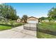 Charming home with a well-manicured lawn and driveway, complemented by a gated entrance at 6701 Nw 6Th Ave, Ocala, FL 34475