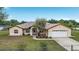 Inviting single-story home with a two-car garage, tidy landscaping, and a spacious front lawn at 6701 Nw 6Th Ave, Ocala, FL 34475