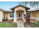 Close-up of the front porch with decorative plants and pillars framing the entrance of the home at 6701 Nw 6Th Ave, Ocala, FL 34475