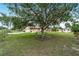 Charming home nestled in a lush, green yard with mature shade trees and well-maintained landscaping at 6701 Nw 6Th Ave, Ocala, FL 34475