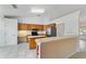 Open kitchen design featuring an island, breakfast bar, and stainless appliances at 6701 Nw 6Th Ave, Ocala, FL 34475