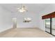 Bright living room featuring a ceiling fan and sliding glass doors to a patio at 6701 Nw 6Th Ave, Ocala, FL 34475