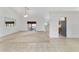 Open living area with tile floors, a ceiling fan, and access to the screened-in porch at 6701 Nw 6Th Ave, Ocala, FL 34475