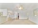 Spacious living area with tile and carpet flooring, ceiling fan, and open layout to the dining area at 6701 Nw 6Th Ave, Ocala, FL 34475