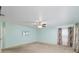Large primary bedroom with a ceiling fan, carpet, and windows at 6701 Nw 6Th Ave, Ocala, FL 34475