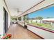Spacious screened porch featuring tile flooring, ceiling fans, and windows overlooking the backyard at 6701 Nw 6Th Ave, Ocala, FL 34475