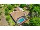 Expansive aerial view of a home with a screened-in pool and well-maintained landscaping at 18498 Sw 69Th Loop, Dunnellon, FL 34432