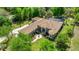 Beautiful aerial view of a home featuring lush landscaping, a pool, and a long driveway at 18498 Sw 69Th Loop, Dunnellon, FL 34432