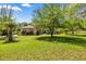 Lovely front yard and exterior view of a well-manicured home with mature trees at 18498 Sw 69Th Loop, Dunnellon, FL 34432