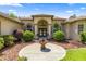 Close up of the front entrance of a lovely home with decorative shrubs and fountain at 18498 Sw 69Th Loop, Dunnellon, FL 34432