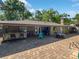 Spacious backyard patio with bar, seating area, and a glimpse of the refreshing pool at 4085 Se 23Rd Ter, Ocala, FL 34480
