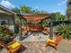 Cozy pergola with fire pit and seating area, perfect for outdoor entertaining at 4085 Se 23Rd Ter, Ocala, FL 34480