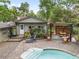 Backyard pool with an outdoor kitchen, lounge area, and extensive hardscape at 4085 Se 23Rd Ter, Ocala, FL 34480