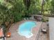 Aerial view of the backyard pool, outdoor seating, and mature trees at 4085 Se 23Rd Ter, Ocala, FL 34480