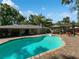 Backyard featuring a sparkling pool surrounded by a brick patio and lush landscaping at 4085 Se 23Rd Ter, Ocala, FL 34480