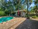 Poolside view with shed, seating, and a grill, perfect for outdoor gatherings and relaxation at 4085 Se 23Rd Ter, Ocala, FL 34480