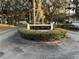 Welcoming entrance to Country Club Village featuring a lush, landscaped sign surrounded by mature trees at 8142 Fairways Cir # S204, Ocala, FL 34472