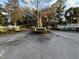 Community entrance to Country Club Village with landscaped sign surrounded by mature trees on a sunny day at 8142 Fairways Cir # S204, Ocala, FL 34472