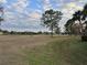 Picturesque open field with mature trees and clear skies, offering a great view for outdoor activities and relaxation at 8142 Fairways Cir # S204, Ocala, FL 34472