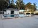 Community swimming pool with tiled edge, lounge chairs and adjacent changing room for residents' outdoor enjoyment at 8142 Fairways Cir # S204, Ocala, FL 34472