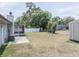 Spacious backyard with a screened lanai, mature trees, and a storage shed at 3990 Se 20Th Ct, Ocala, FL 34480