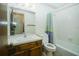 Functional bathroom featuring a tub, toilet, vanity, and wallpaper at 3990 Se 20Th Ct, Ocala, FL 34480