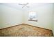 Bright bedroom with a window, ceiling fan, and carpet at 3990 Se 20Th Ct, Ocala, FL 34480